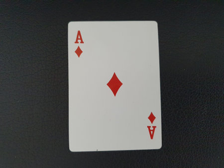 Playing cards on a black leather background, closeup of photo.の写真素材