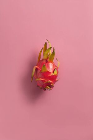 Ripe red dragon fuit on background. Fresh tropical fruit harvest.の写真素材