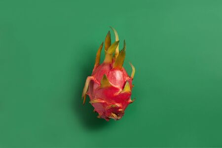 Ripe red dragon fuit on background. Fresh tropical fruit harvest.の写真素材