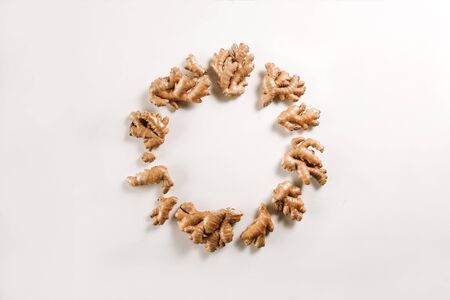 Natural ginger root on white background as a wreath.