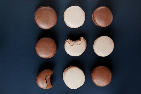 Light cream and chocolate macaroons on black backgroundの写真素材