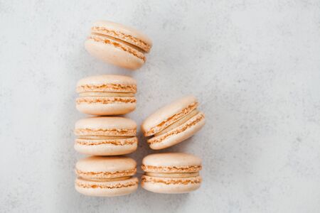 Group of vanilla macaroons on light background