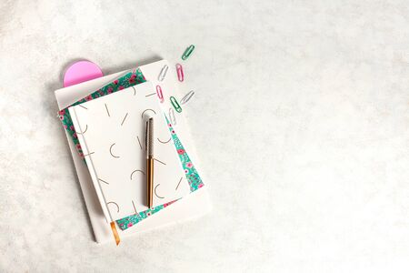 Three notebooks on white background with ink pen and copy spaces. Journal writing and note taking...