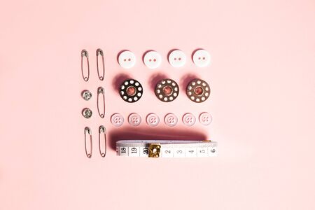 Sewing kit accessories and tools for needle work in pink. Tape measure, pins, scissors, buttons,...