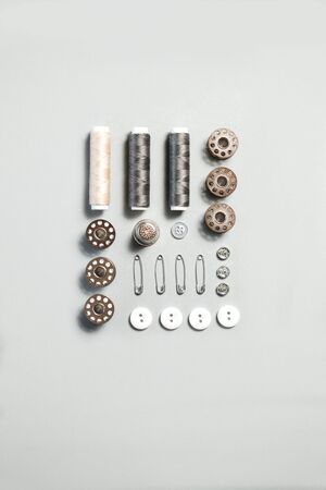 Sewing kit accessories and tools for needle work in gray. Tape measure, pins, scissors, buttons,...