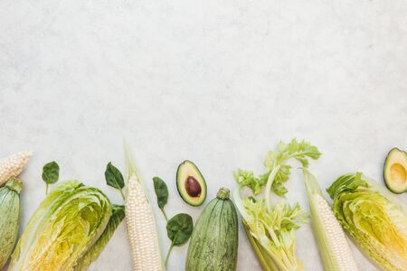 Fresh green produce background with copy space, Green vegetables frame and wreath on white...