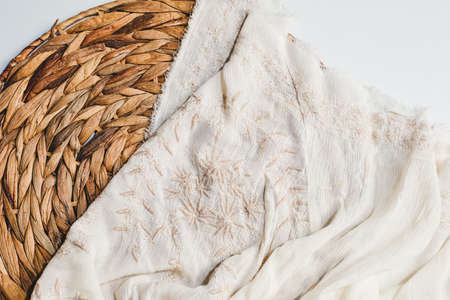 Summer spring background with ratan basket, fresh baby breaths and summer dress with embroideryの写真素材