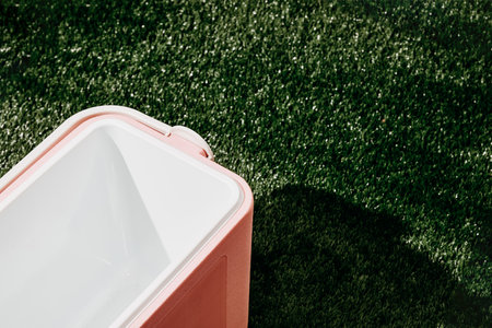 Plastic basin on green grass in football stadium, closeup.