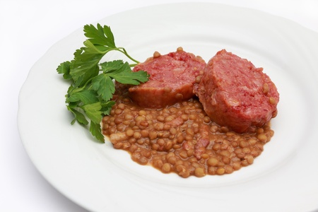 large boiled pork sausage, italian cotechino, with lentils の写真素材