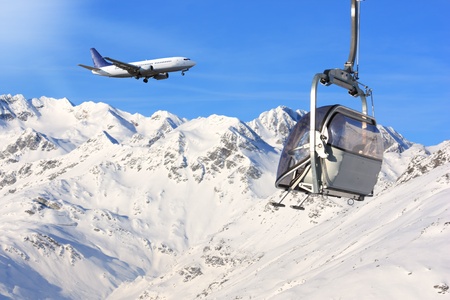 winter shot of airplane overfly italian alps covered in snowの写真素材