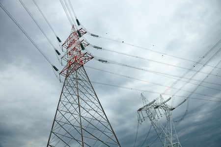 electric high voltage pylon against dramatic sky