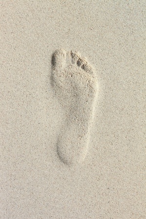 single footprint on beach sandの写真素材