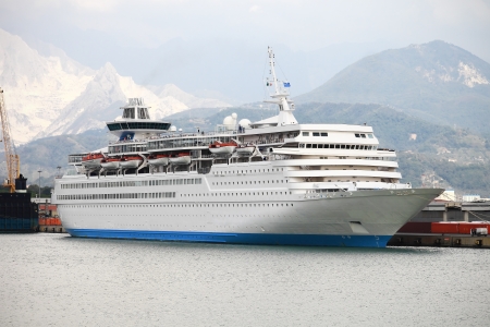 Cruise ship docked in Italy against mountainの写真素材