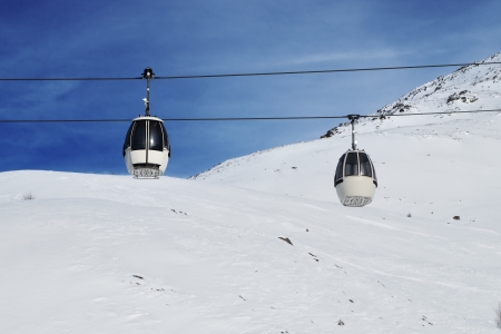 cable cars over the ski slope in italian Alpsの写真素材