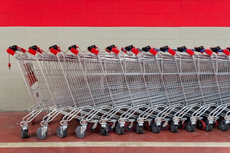 row of shopping trolleys or carts in supermarketの写真素材