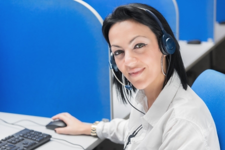 Female customer support operator with headset smilingの写真素材