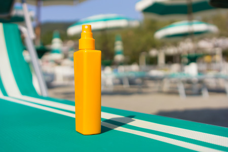 sun protection cream on sunbed in the beachの写真素材
