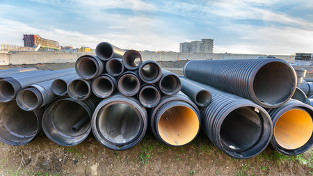 stacked pipes in construction siteの写真素材