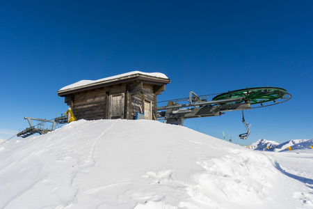 wooden hut and ski lift in mountainの写真素材