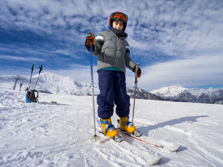 Skiing, portrait of young kid skier on ski slopeの写真素材