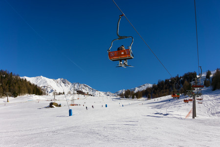 ski slope and chair lift in Pila, Aosta, Italyの写真素材