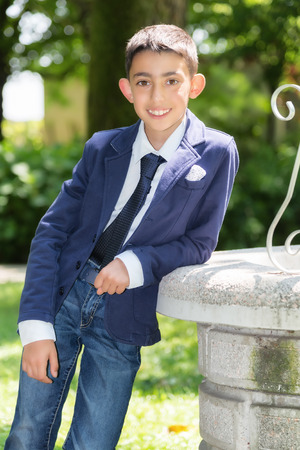 casual young boy with tie smilingの写真素材