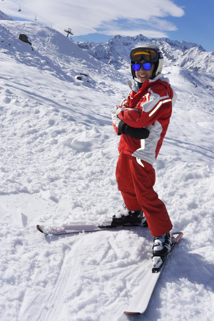 Smiling boy in ski suit on the slopeの写真素材