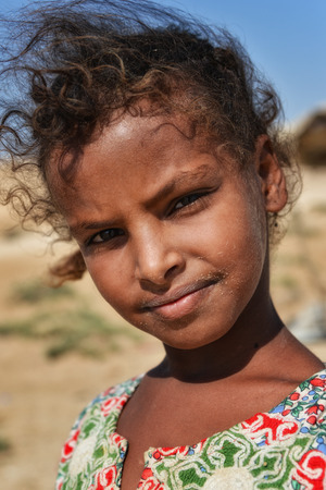BERENICE, EGYPT - OCTOBER 7, 2016: Portrait of unidentified African Bedouin kid. Bedouins are people  who live stationary or nomadic lifestyles outside cities and towns.のeditorial素材