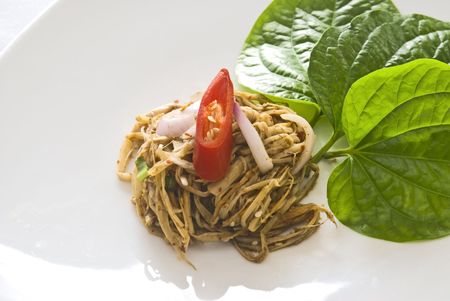 Spicy bamboo salad topped with a sliced red pepper. Traditional Thao Cuisine.の写真素材