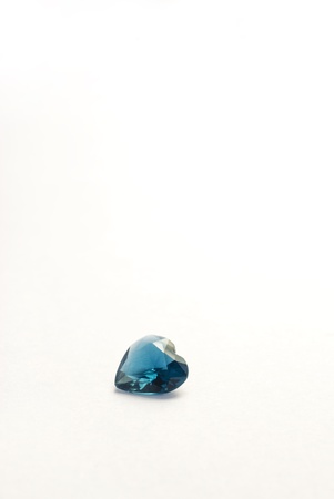 A single heart shaped sapphire on a white backgroundの写真素材