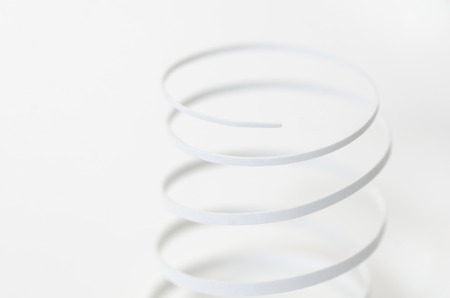 A horizontal image of a white paper spiral on a white backgroundの写真素材