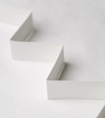 A vertical image of white paper steps on a white backgroundの写真素材