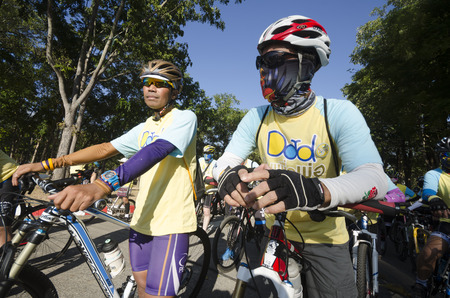 Chiang Mai, Thailand - December 11, 2015: Two cyclists wait for the Bike For Dad event to begin on December 11, 2015 in Chiang Mai, Thailand. The Bike For Dad cycling event attracts hundreds of thousands of cyclists and is held across Thailand to celebratのeditorial素材