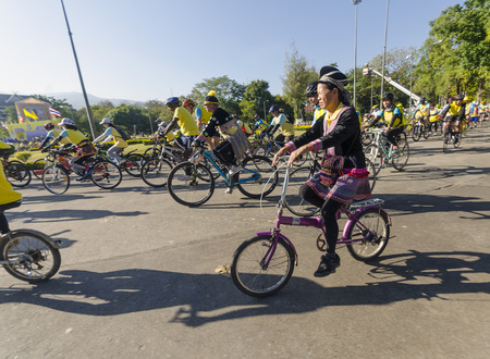 Chiang Mai, Thailand - December 11, 2015: A woman from a Hmong Hilltribe rides among other cyclists at the Bike For Dad event on December 11, 2015 in Chiang Mai, Thailand. The Bike For Dad cycling event attracts hundreds of thousands of cyclists and is heのeditorial素材