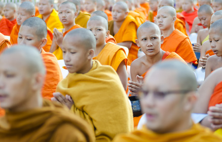 Chiang Mai, Thailand - December 26, 2015: Young Buddhist monks attend a special alms offering ceremony organized for 10,000 monks by Wat Phra Dhammakaya on December 26, 2015 in Chiang Mai, Thailand.のeditorial素材