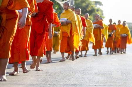 Chiang Mai, Thailand - December 26, 2015: Young Buddhist monks attend a special alms offering ceremony organized for 10,000 monks by Wat Phra Dhammakaya on December 26, 2015 in Chiang Mai, Thailand.のeditorial素材