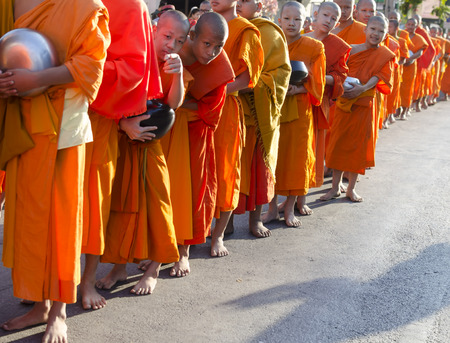 Chiang Mai, Thailand - December 26, 2015: Young Buddhist monks attend a special alms offering ceremony organized for 10,000 monks by Wat Phra Dhammakaya on December 26, 2015 in Chiang Mai, Thailand.のeditorial素材