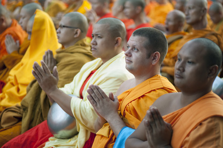 Chiang Mai, Thailand - December 26, 2015: A western Buddhist monk attends a special alms offering ceremony organized for 10,000 monks by Wat Phra Dhammakaya among Thai monks on December 26, 2015 in Chiang Mai, Thailand.のeditorial素材