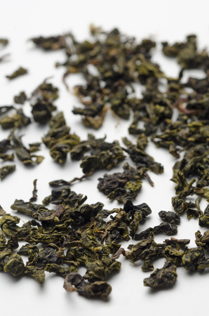 A vertical image of green organic tea on a white ceramic plateの写真素材