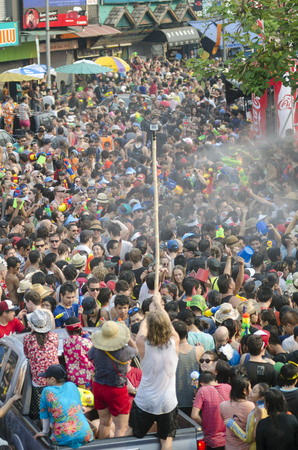 Chiang Mai, Thailand - April 14, 2014: A young man films a large group of people with a GoPro camera during the Songkran festival in Chiang Mai, Thailand on April 14, 2014.のeditorial素材
