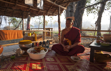 Pai, Thailand - February 17, 2016: A Theravada Buddhist monk sits in his forest bamboo hut in the woods near the village of Pai, Thailand on February 17, 2016.のeditorial素材