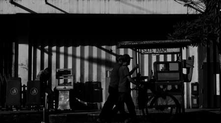 People passing by a stallのeditorial素材