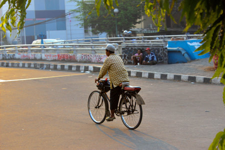 An old man rides a traditional bikeの写真素材