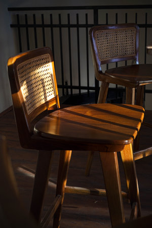 A chair in a coffee shop exposed to ray of sunlightの写真素材