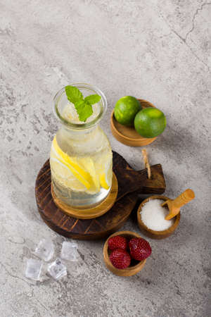 iced lemon with sparkling soda water on wooden coaster and white background textureの写真素材