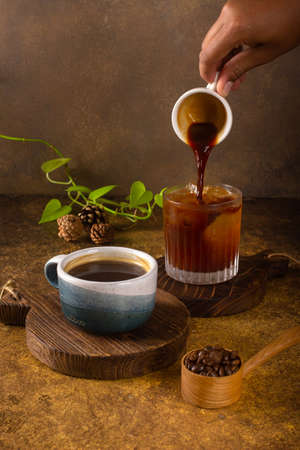 aromatic coffee from fresh roasted coffee bean to pouring become hot or cold black coffee at wooden rustic trayの写真素材