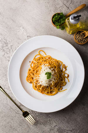 Italian Pasta spaghetti bolognese with minced beef sauce and parmesan cheese in white plate on texture tableの写真素材