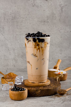 Boba or tapioca pearls is taiwan bubble milk tea in plastic cup with brown sugar flavor on texture  background, summers refreshment.の写真素材