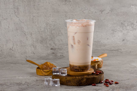 Boba or tapioca pearls is taiwan bubble milk tea in plastic cup with milk flavor on texture  background, summers refreshment.の写真素材