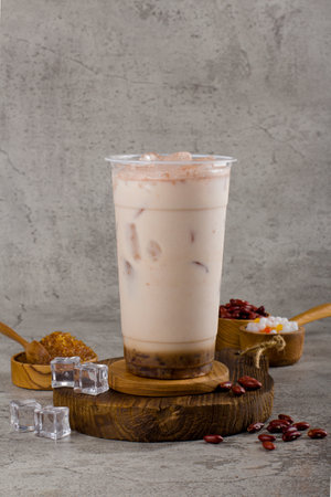 Boba or tapioca pearls is taiwan bubble milk tea in plastic cup with milk flavor on texture  background, summers refreshment.の写真素材